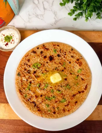 Paneer jalapeño spinach stuffed paratha served with yogurt and pickle