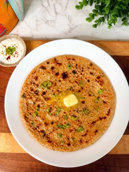 Paneer jalapeño spinach stuffed paratha served with yogurt and pickle