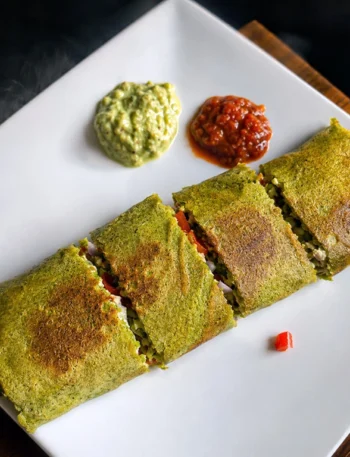 32g protein chilla wrap with mung bean quinoa batter and paneer stuffing cut on a plate