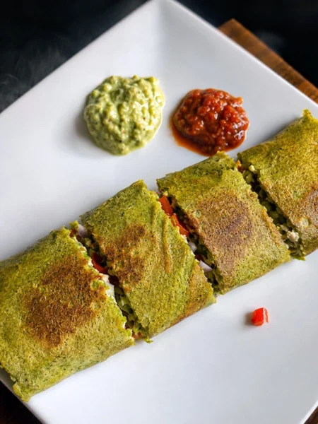 32g protein chilla wrap with mung bean quinoa batter and paneer stuffing cut on a plate