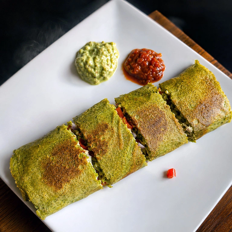 32g protein chilla wrap with mung bean quinoa batter and paneer stuffing cut on a plate