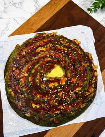 Golden stuffed paneer paratha served with butter and green chutney