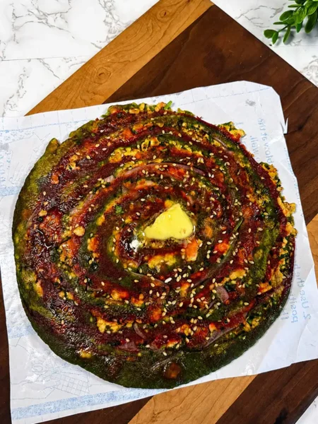 Golden stuffed paneer paratha served with butter and green chutney