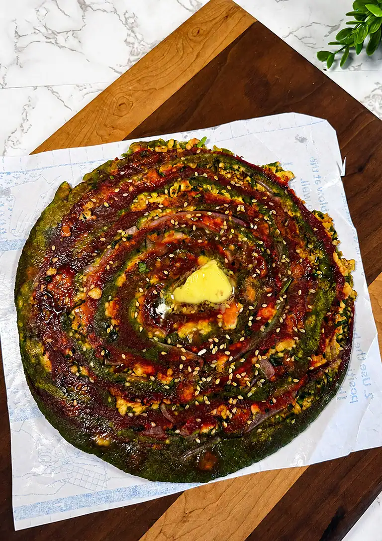 Golden stuffed paneer paratha served with butter and green chutney